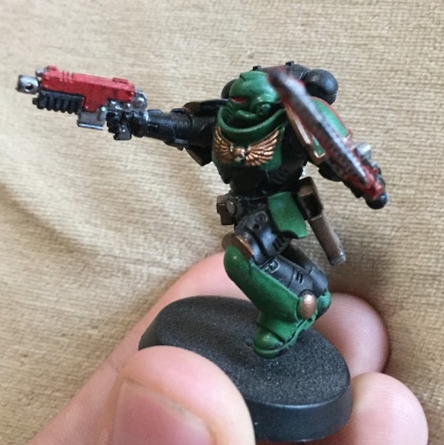 Green and black solider with pistol and sword